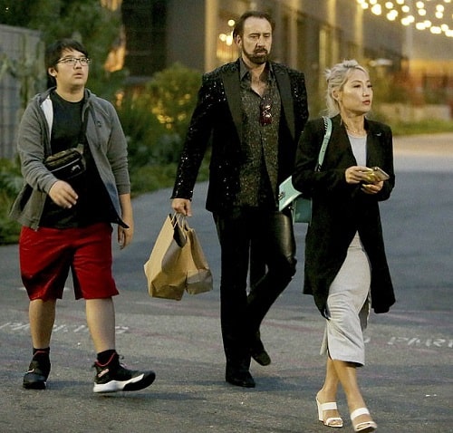 A picture of Alice Kim with her ex-husband and teenager son coming out of the restaurant.